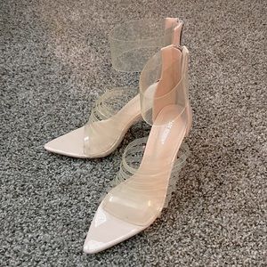 Clear strappy heels w nude base.